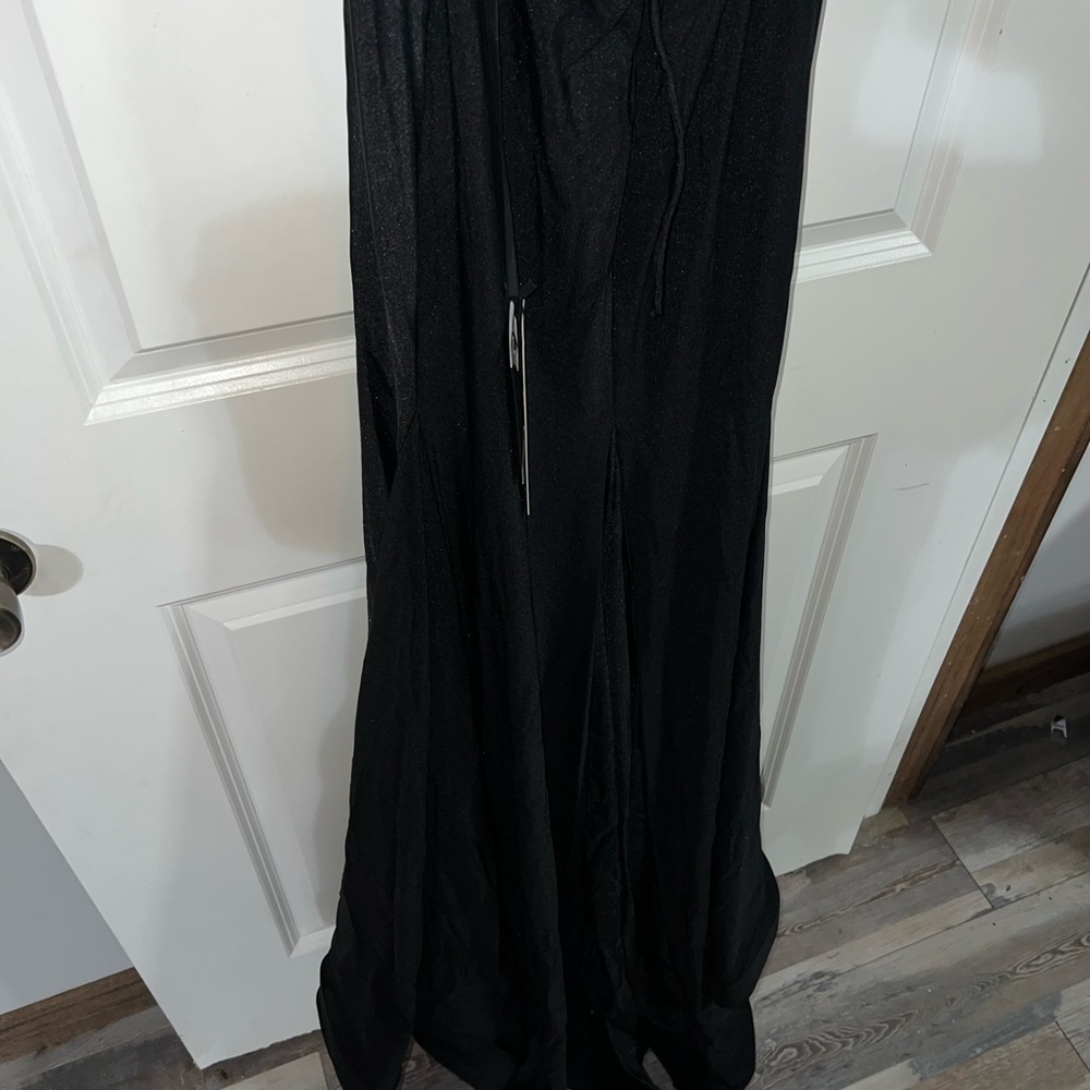 Black formal gown size 6, never worn. Backless with lace up back.